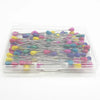 A clear plastic tray filled with various colored pearl teardrop corsage boutonniere pins for crafting.