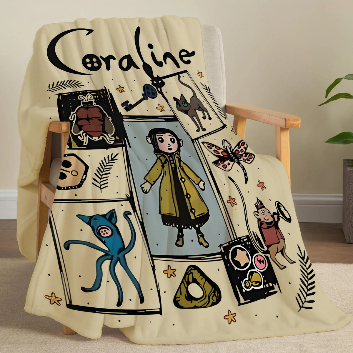 A beige flannel throw blanket featuring a black line drawing of a girl and various whimsical illustrations.