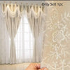 A close-up of a sheer white and beige dual-layer embroidered window curtain with decorative fringe and lace detailing.