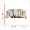 A white embroidered patch with the text GOD IS GOOD all the time, shown next to a ruler and weight scale.
