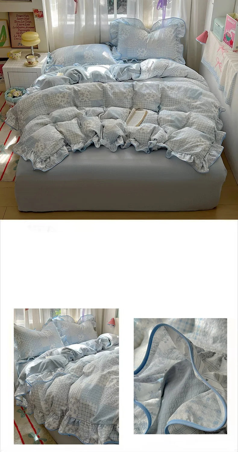 A light blue and gray floral bedding set featuring a duvet cover, pillows, and decorative accents.