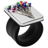 A silver magnetic wrist pincushion filled with colorful pins and a silicone band.