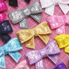 Assortment of sparkly sequin bow patches in various colors like silver gold pink purple and blue