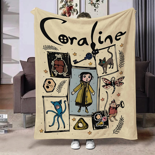A cream colored flannel throw blanket featuring a black line drawing of the name Coraline and various whimsical illustrations