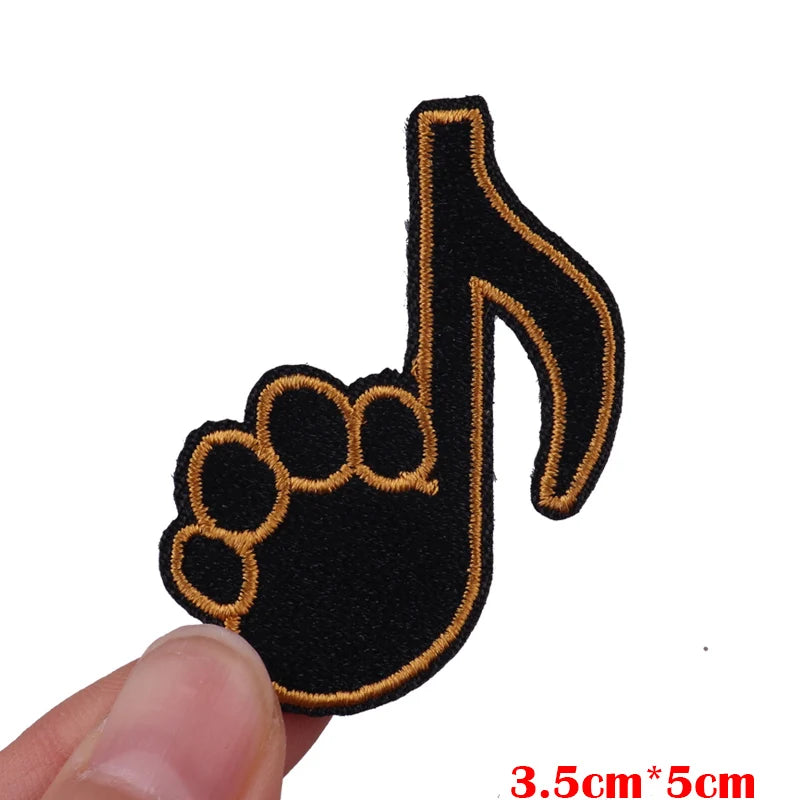 Black and gold embroidered musical note hand print patch