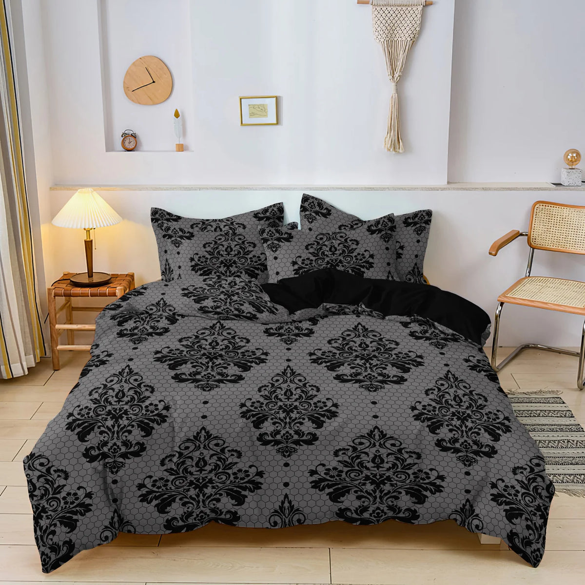 A black and gray damask pattern duvet cover set displayed on a bed with wooden side tables and white walls.