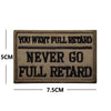 A dark brown embroidered patch with black text that reads YOU WENT FULL RETARD NEVER GO FULL RETARD