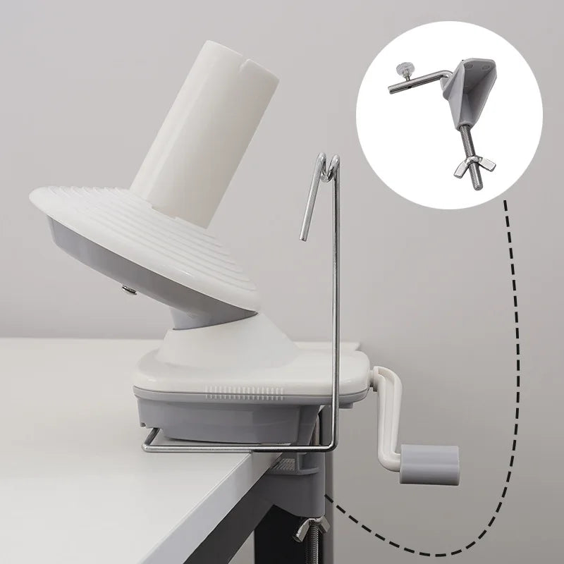 A hand operated wool yarn winder device with a visible winding mechanism and a separate dispensing nozzle.