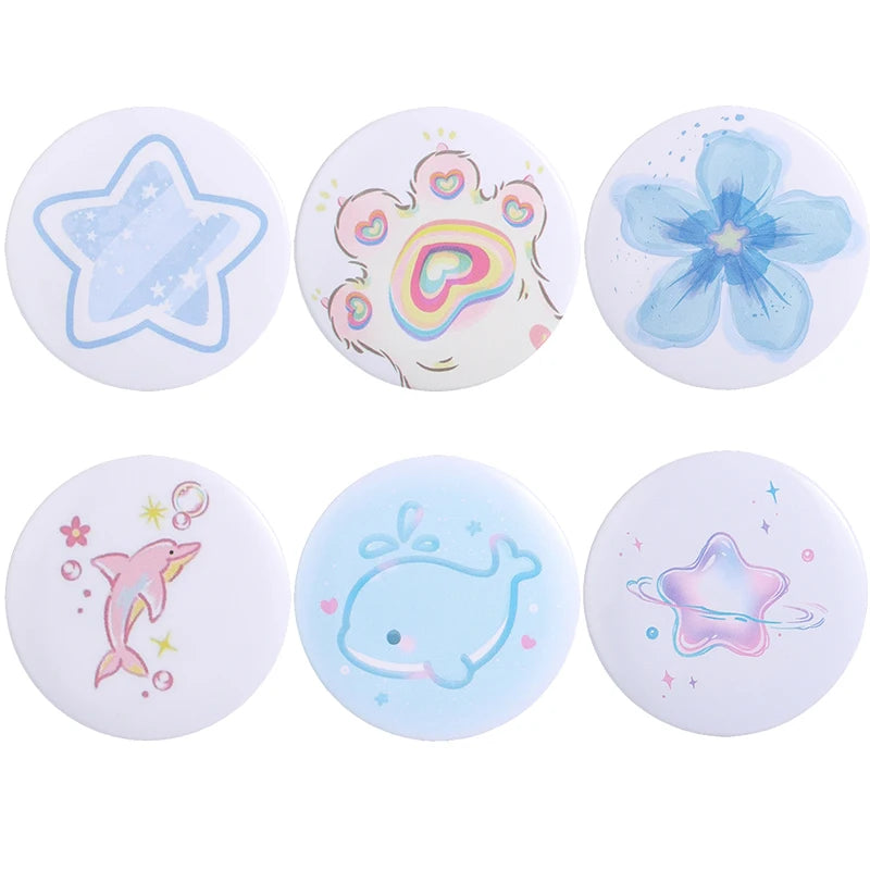 A set of five tinplate pin brooches featuring various animal and music-themed designs like a star, a heart, a flower, a pink 