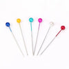 A set of colorful pearl head pins with various colored beads and silver-toned pins.
