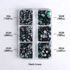 A clear plastic tray containing various sizes of dark green glass rhinestones categorized by SS6, SS10, SS10, SS30, SS20, and
