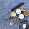A metal jeans button repair kit featuring a screwdriver and multiple brass and silver buttons on a denim background.