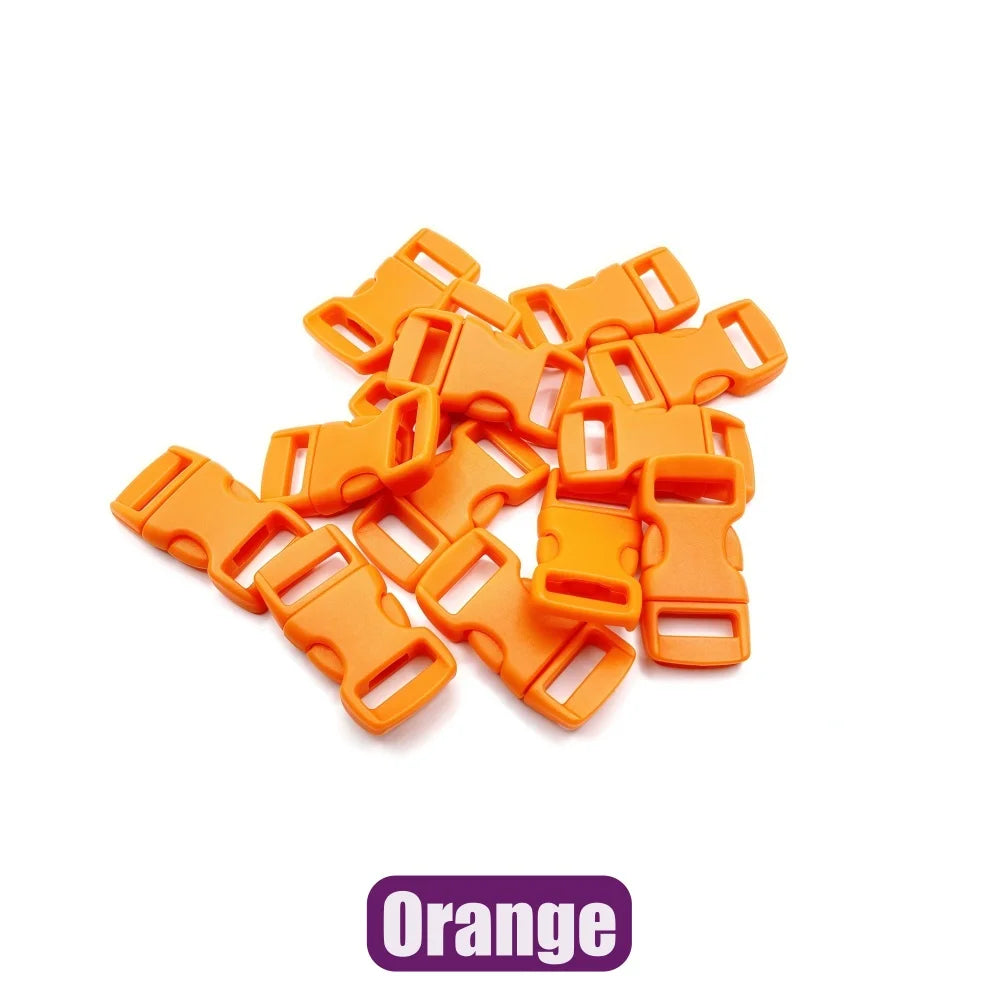 A pile of orange adjustable plastic paracord buckle bracelets.