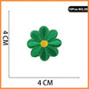 A set of 10 embroidered iron-on patches featuring a green flower with a yellow center.