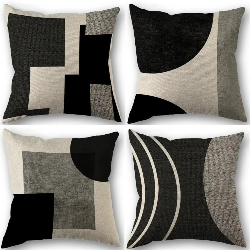 A set of four abstract geometric pillow covers in black, gray, and beige tones.
