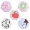 A set of five colorful tinplate pins featuring themes like flowers, strawberries, music notes, and a star.