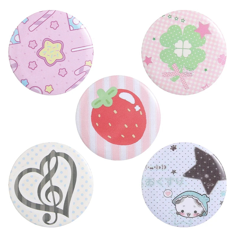 A set of five colorful tinplate pins featuring themes like flowers, strawberries, music notes, and a star.