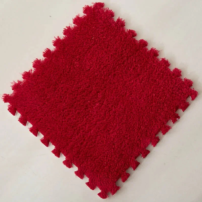 A square red plush interlocking puzzle rug mat with a textured surface.