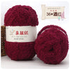A stack of deep red fuzzy yarn balls labeled as QINFUSHOUZUO 36 Wood Red for crafting.