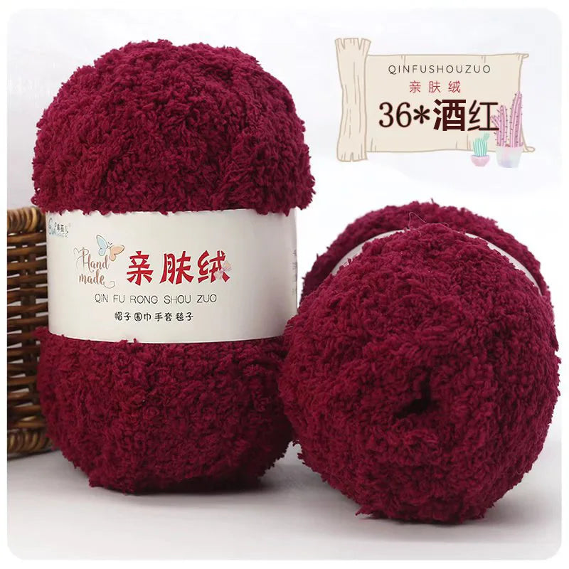 A stack of deep red fuzzy yarn balls labeled as QINFUSHOUZUO 36 Wood Red for crafting.