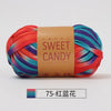 A ball of hand-dyed yarn featuring stripes of orange, pink, purple, and teal colors, labeled Sweet Candy.