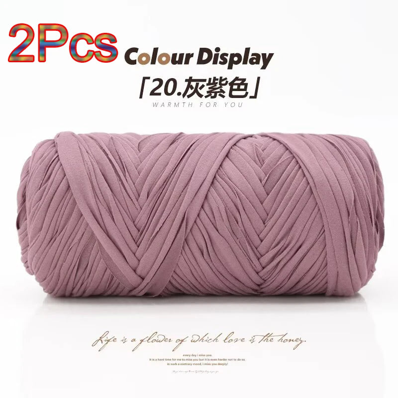 Two skeins of mauve elastic yarn used for crafting with a color display.