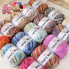 A collection of six balls of gradient alpaca wool yarn in various colors and textures for knitting and crochet projects.