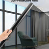 A hand holds a black heat-insulating and sun-protective film, demonstrating its use on a window.
