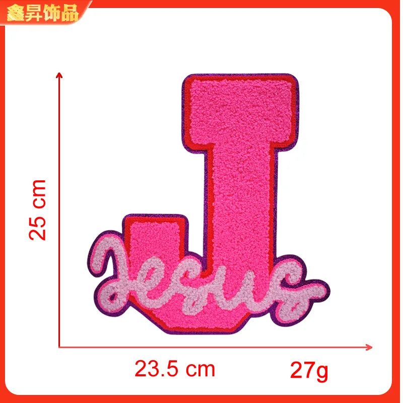 Pink iron-on embroidery patch shaped like the letter T with the word Jesus written below