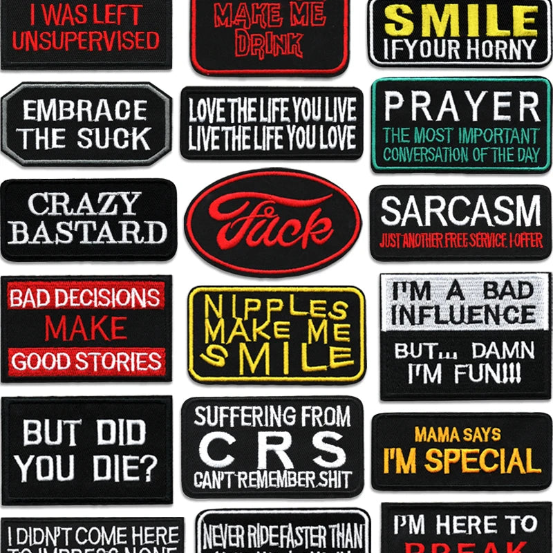 A collection of black iron-on embroidered letter patches with various phrases like MAKE ME DRINK, SMILE IF YOUR HORNY, and SA