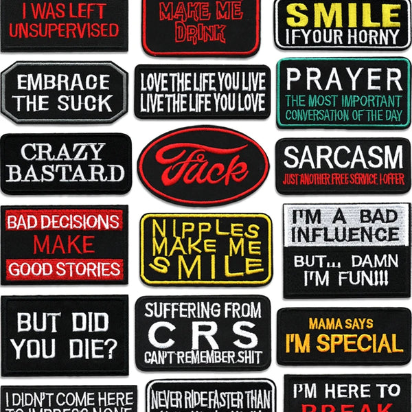 A collection of black iron-on embroidered letter patches with various phrases like MAKE ME DRINK, SMILE IF YOUR HORNY, and SA