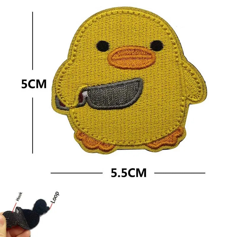 Yellow embroidered patch of a duck with a black beak and tactical stitching