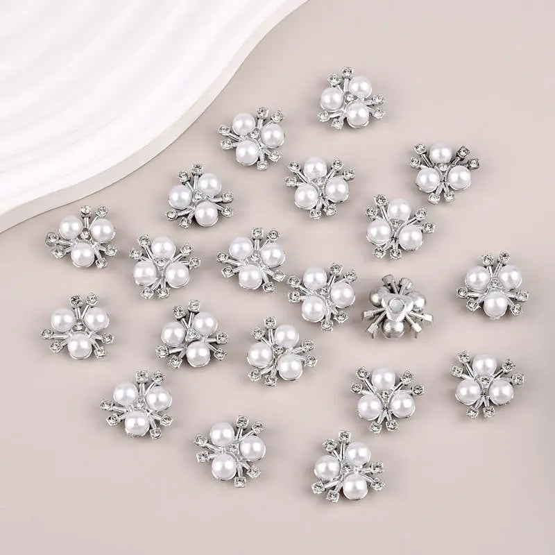 A collection of flower-shaped resin button rhinestones in silver color.