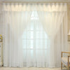White sheer double-layer curtains covering a large window with a pointed arch shape