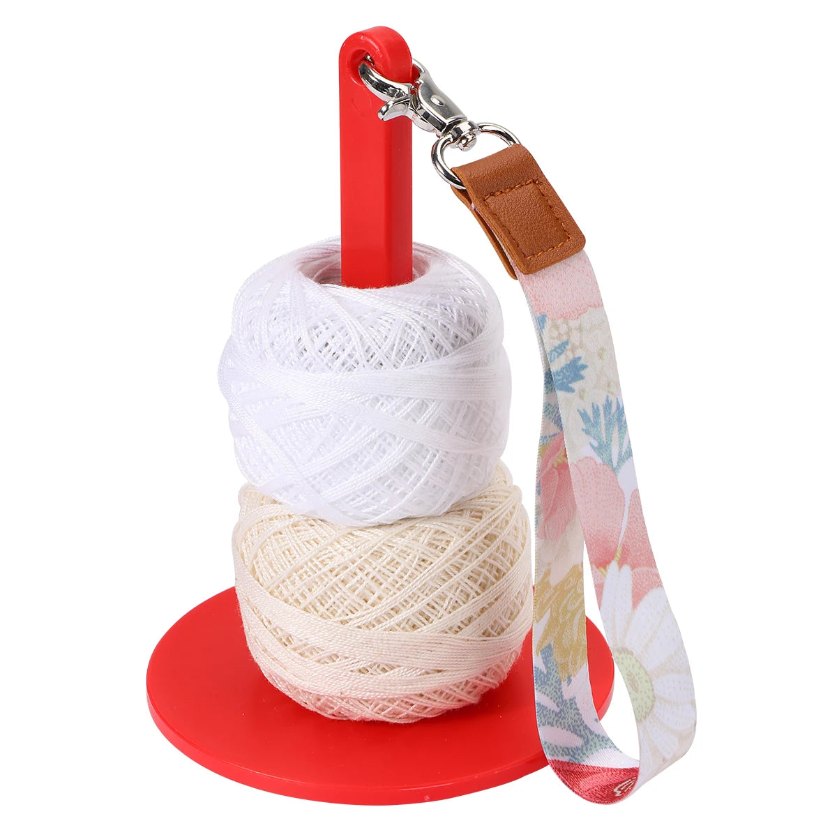 A red yarn holder with a clip and a beige patterned fabric strap for winding knitting yarn.