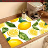 A yellow lemon printed non-slip dish drying mat with green leaves.