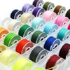 Assortment sewing thread bobbins set showing various colors of thread spools.