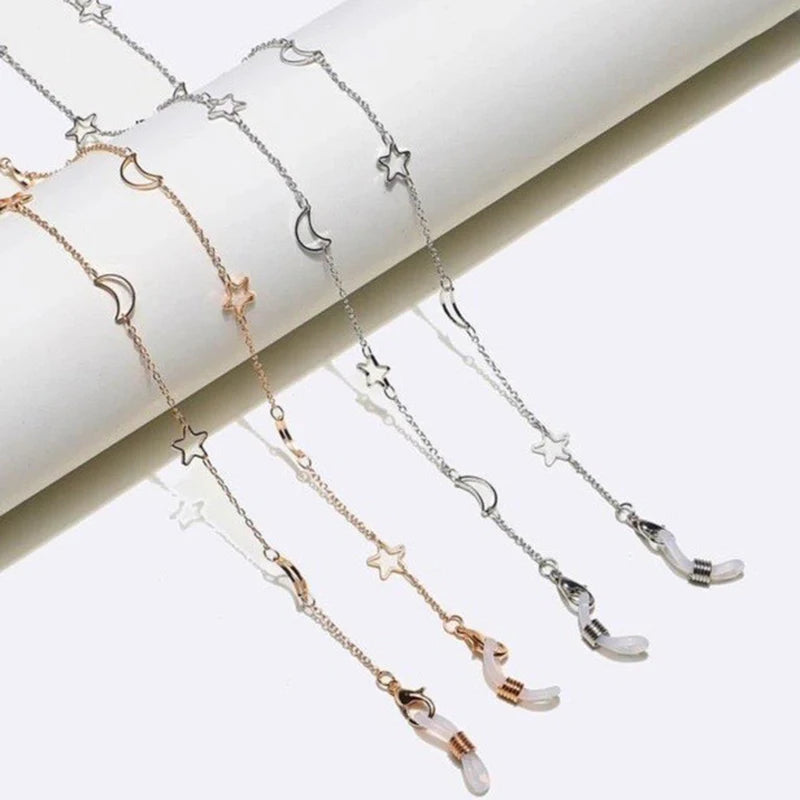 A delicate gold and silver star moon locket necklace displayed on a white background.