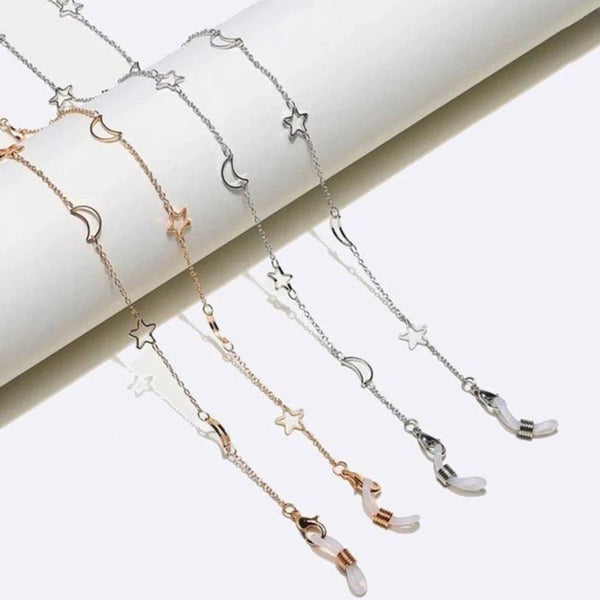 A delicate gold and silver star moon locket necklace displayed on a white background.