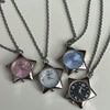 Silver chain necklace featuring a star-shaped pocket watch with a light blue face and silver hands.