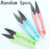 A set of five random U-shape sewing scissors in various colors including black, pink, and green.