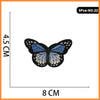 A set of five embroidered butterfly and rose iron-on patches.