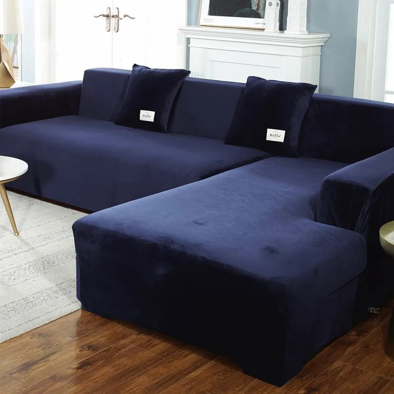 A deep navy velvet sofa cover for an L-shaped sectional sofa in a living room setting.