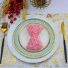 Pink glitter hair accessory displayed on a white plate with gold rim and green patterned plate on a gold confetti runner.