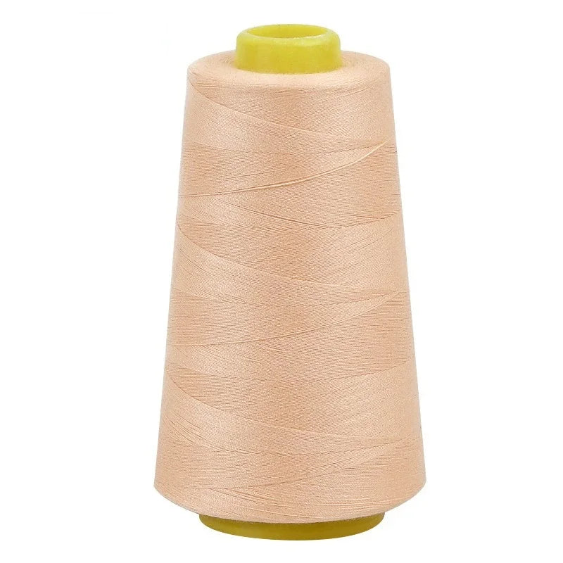 A roll of light beige sewing thread on a yellow spool.