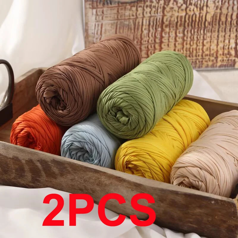 Five spools of reusable elastic yarn in various colors including terracotta, olive green, light blue, yellow, and beige, disp