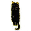 A black cartoon cat plush rug with yellow trim.