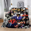 A black and white printed flannel blanket featuring portraits of pop music artists.