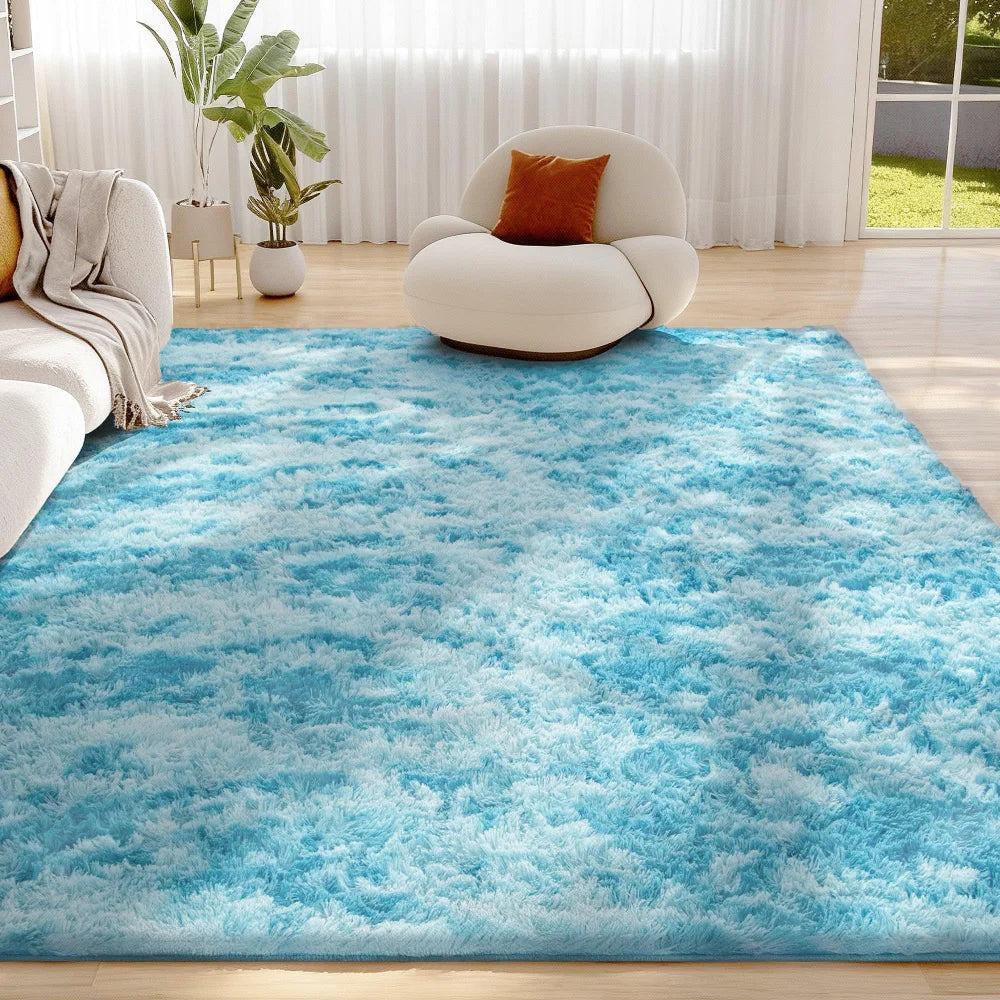 A bright blue shaggy rug with white tips is placed on a wooden floor in a bright living room setting.