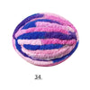 A round ball of vibrant pink and blue hand-knitted yarn with a striped pattern.